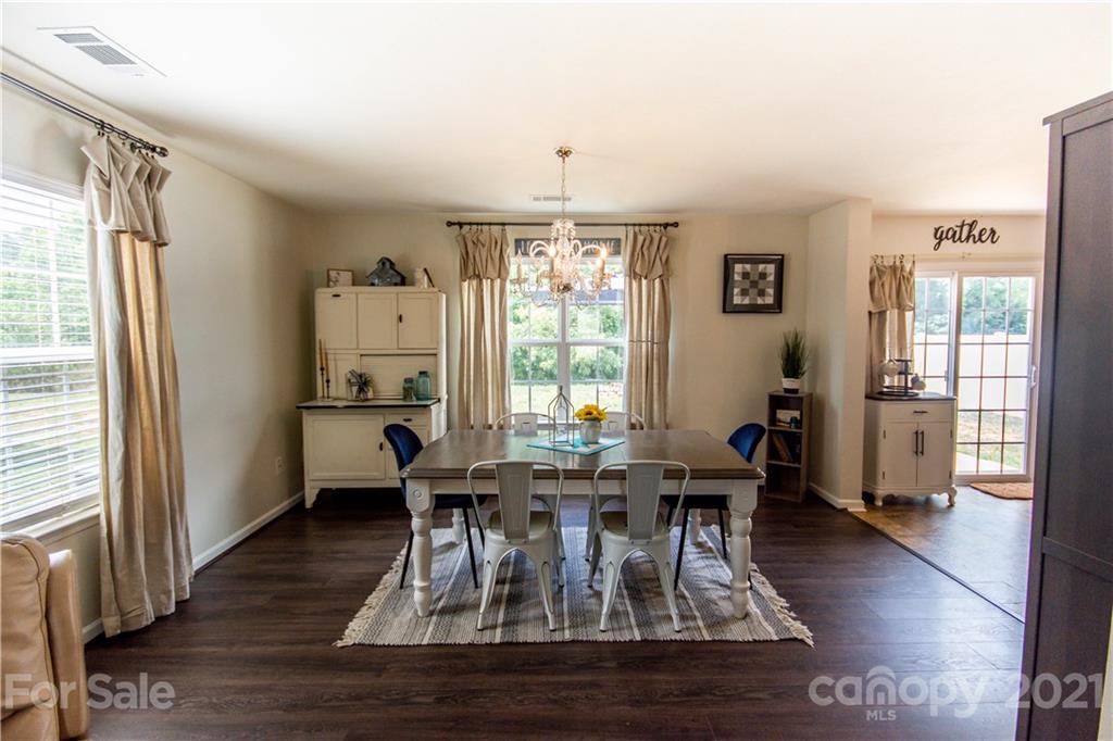 129 Mossy Pond Road Statesville, NC 28677 - Photo 11 of 47 a view of a dining room with furniture window and wooden floor