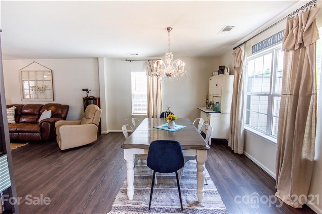 129 Mossy Pond Road Statesville, NC 28677 - Photo 12 of 47 a living room with furniture and a chandelier
