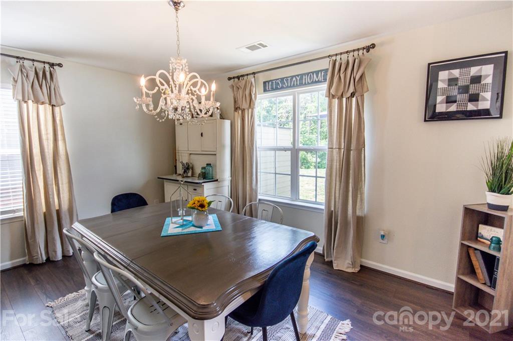 129 Mossy Pond Road Statesville, NC 28677 - Photo 13 of 47 a view of a dining room with furniture window and wooden floor