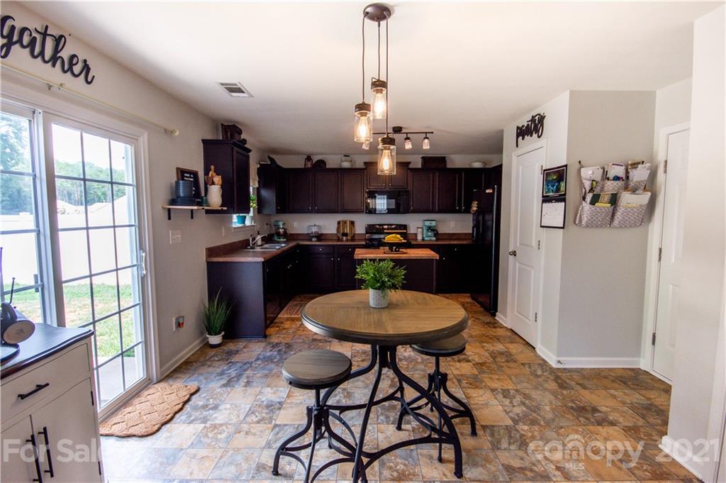 129 Mossy Pond Road Statesville, NC 28677 - Photo 15 of 47 a view of a dining room with furniture window and wooden floor