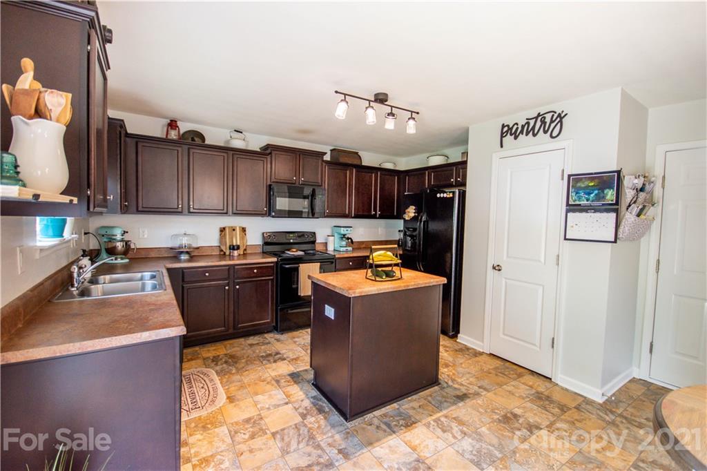 129 Mossy Pond Road Statesville, NC 28677 - Photo 17 of 47 a kitchen with a refrigerator a sink and a stove