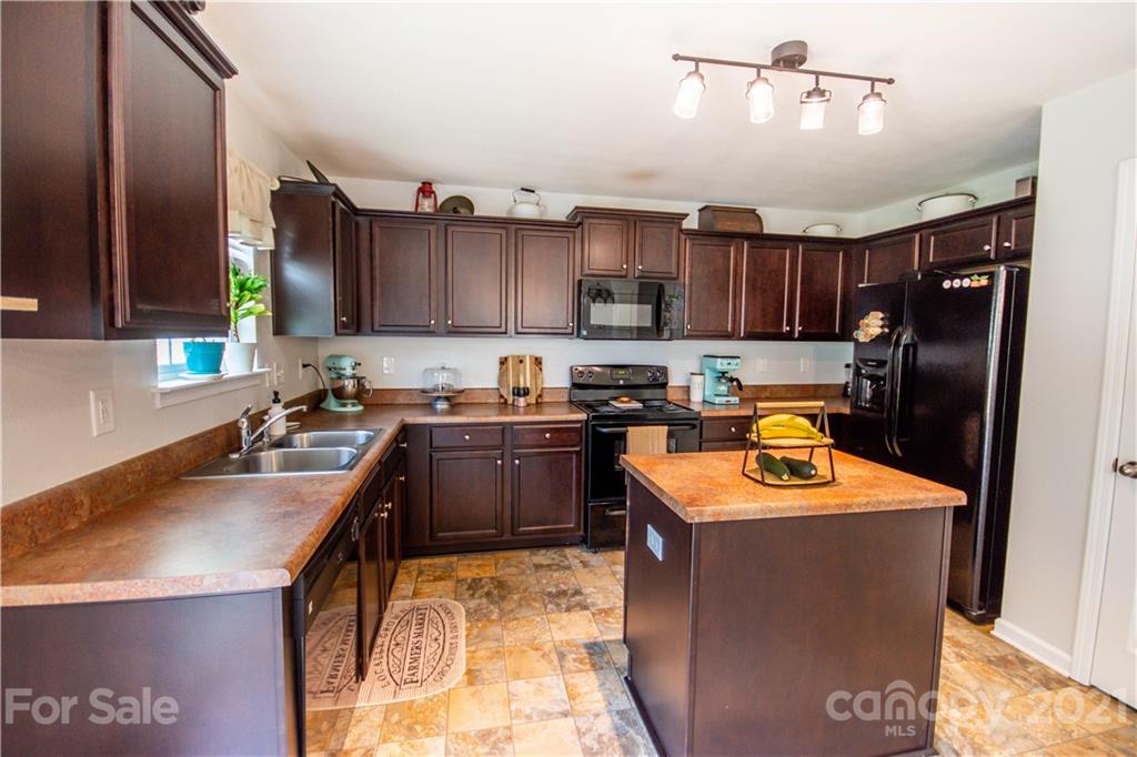 129 Mossy Pond Road Statesville, NC 28677 - Photo 19 of 47 a kitchen with a sink a stove and a refrigerator
