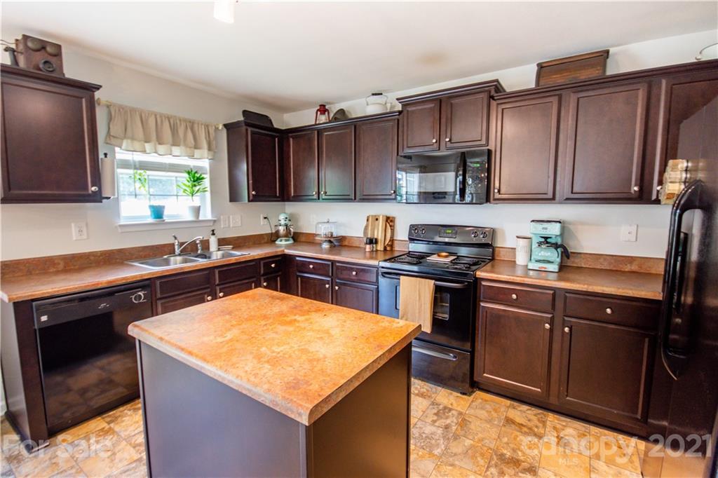 129 Mossy Pond Road Statesville, NC 28677 - Photo 20 of 47 a kitchen with a sink stove top oven and cabinets