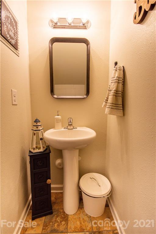 129 Mossy Pond Road Statesville, NC 28677 - Photo 21 of 47 a bathroom with a toilet a sink and mirror