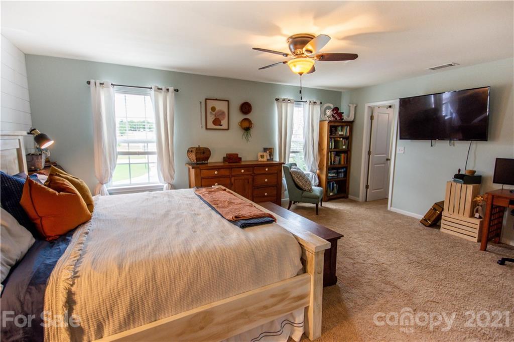 129 Mossy Pond Road Statesville, NC 28677 - Photo 26 of 47 a bedroom with a bed a window and a flat screen television
