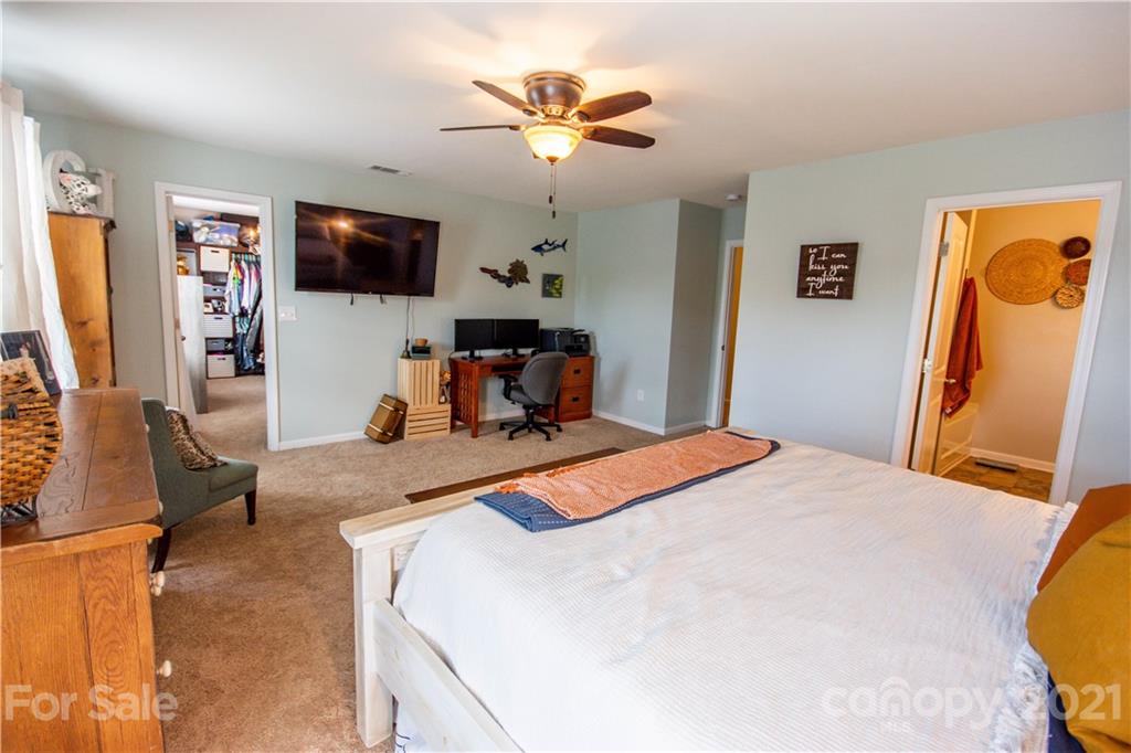129 Mossy Pond Road Statesville, NC 28677 - Photo 27 of 47 a bedroom with a bed and a flat screen tv