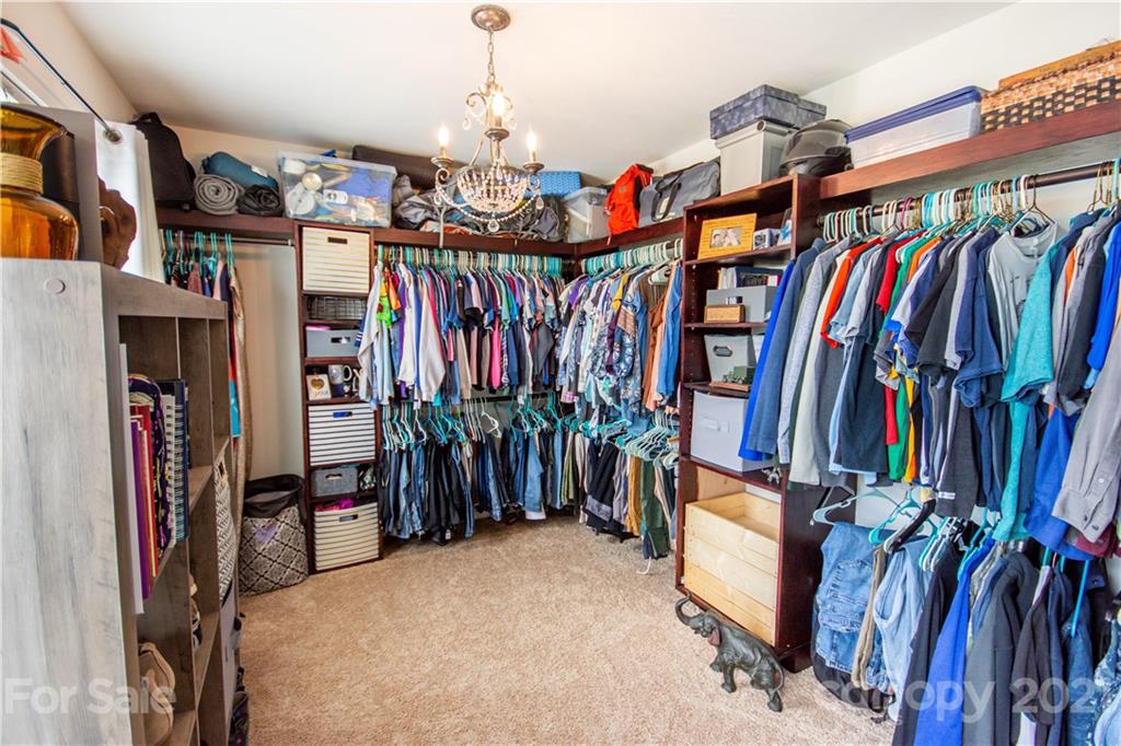 129 Mossy Pond Road Statesville, NC 28677 - Photo 28 of 47 a view of walk in closet with clothes