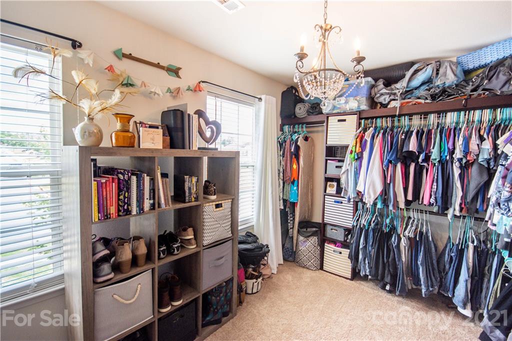129 Mossy Pond Road Statesville, NC 28677 - Photo 29 of 47 a view of walk in closet with clothes and shoes