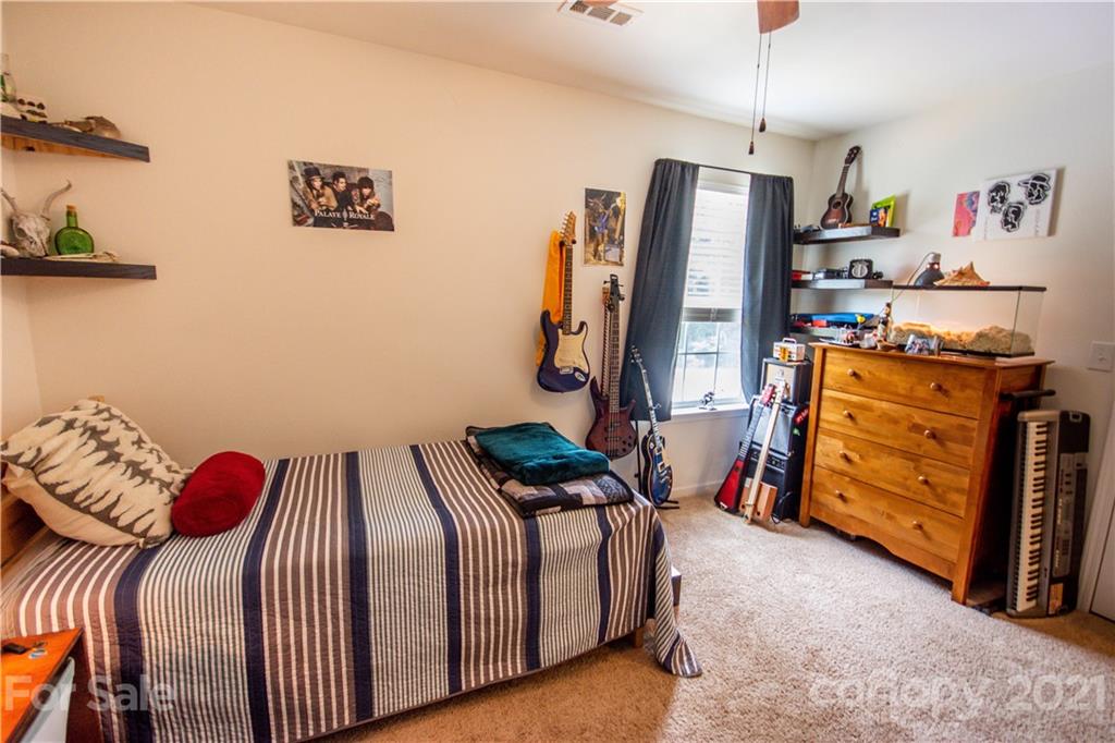 129 Mossy Pond Road Statesville, NC 28677 - Photo 35 of 47 a bedroom with two beds and a closet