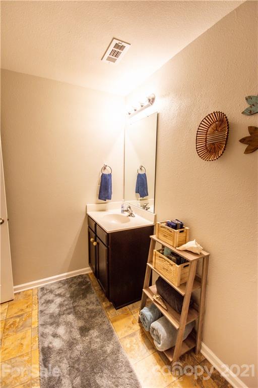 129 Mossy Pond Road Statesville, NC 28677 - Photo 37 of 47 a room with a washing machine and a wooden floor