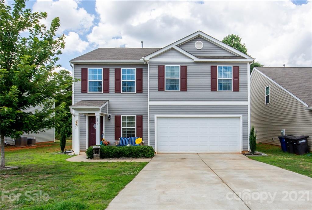 129 Mossy Pond Road Statesville, NC 28677 - Photo 5 of 47 a front view of a house with a garden and plants