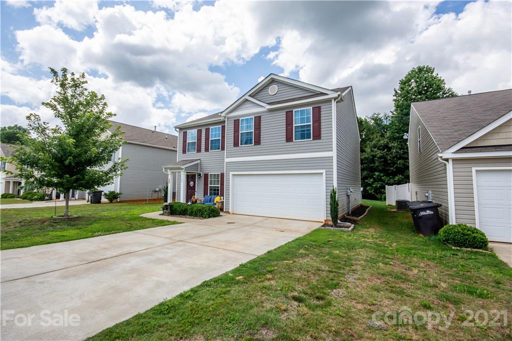 129 Mossy Pond Road Statesville, NC 28677 - Photo 47 of 47 a front view of a house with a yard and garage