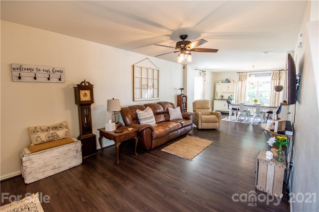 129 Mossy Pond Road Statesville, NC 28677 - Photo 9 of 47 a living room with furniture and a chandelier