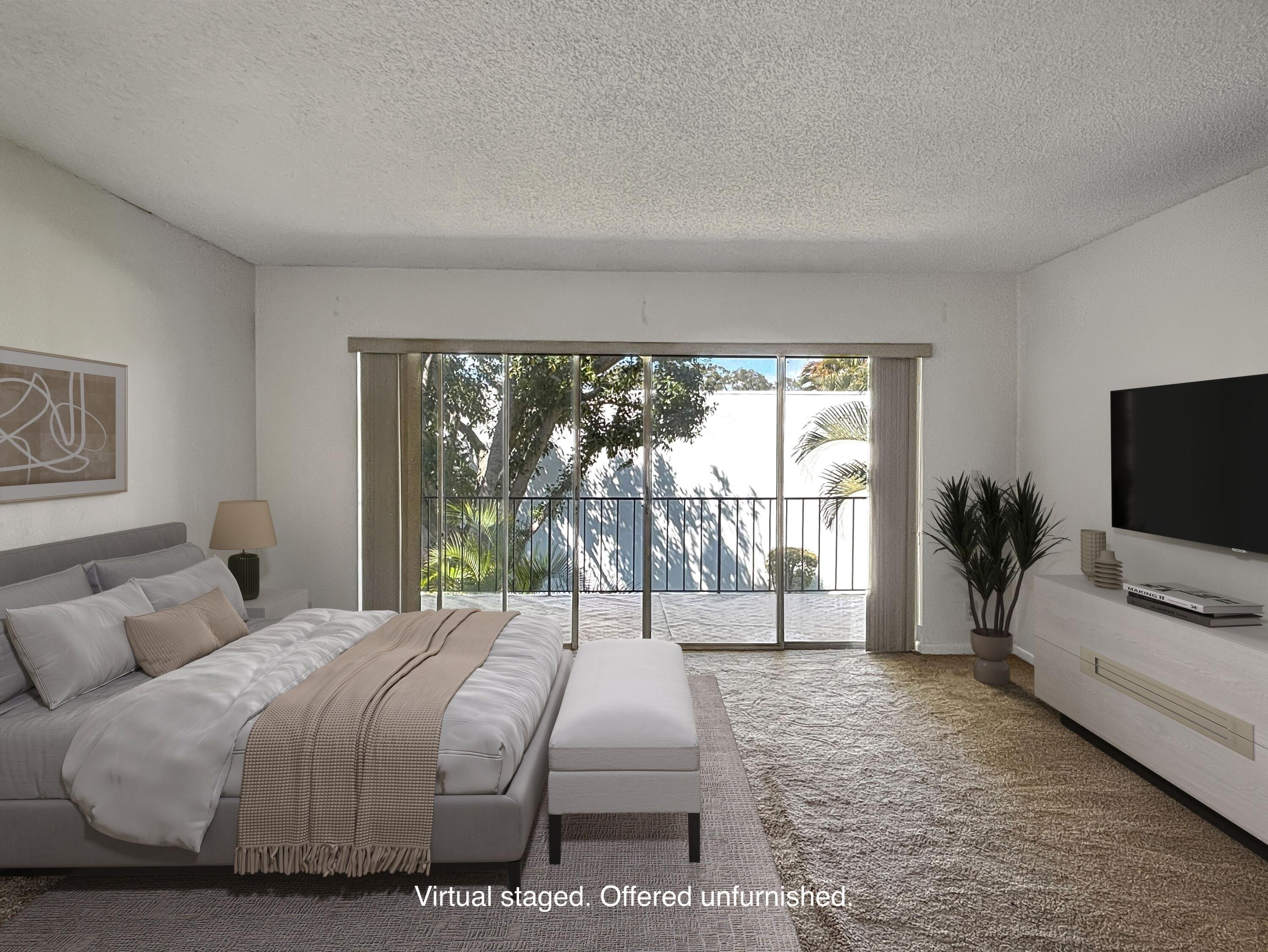 390 Golfview Road, Unit G North Palm Beach, FL 33408 - Photo 12 of 36 a bedroom with a bed and large window
