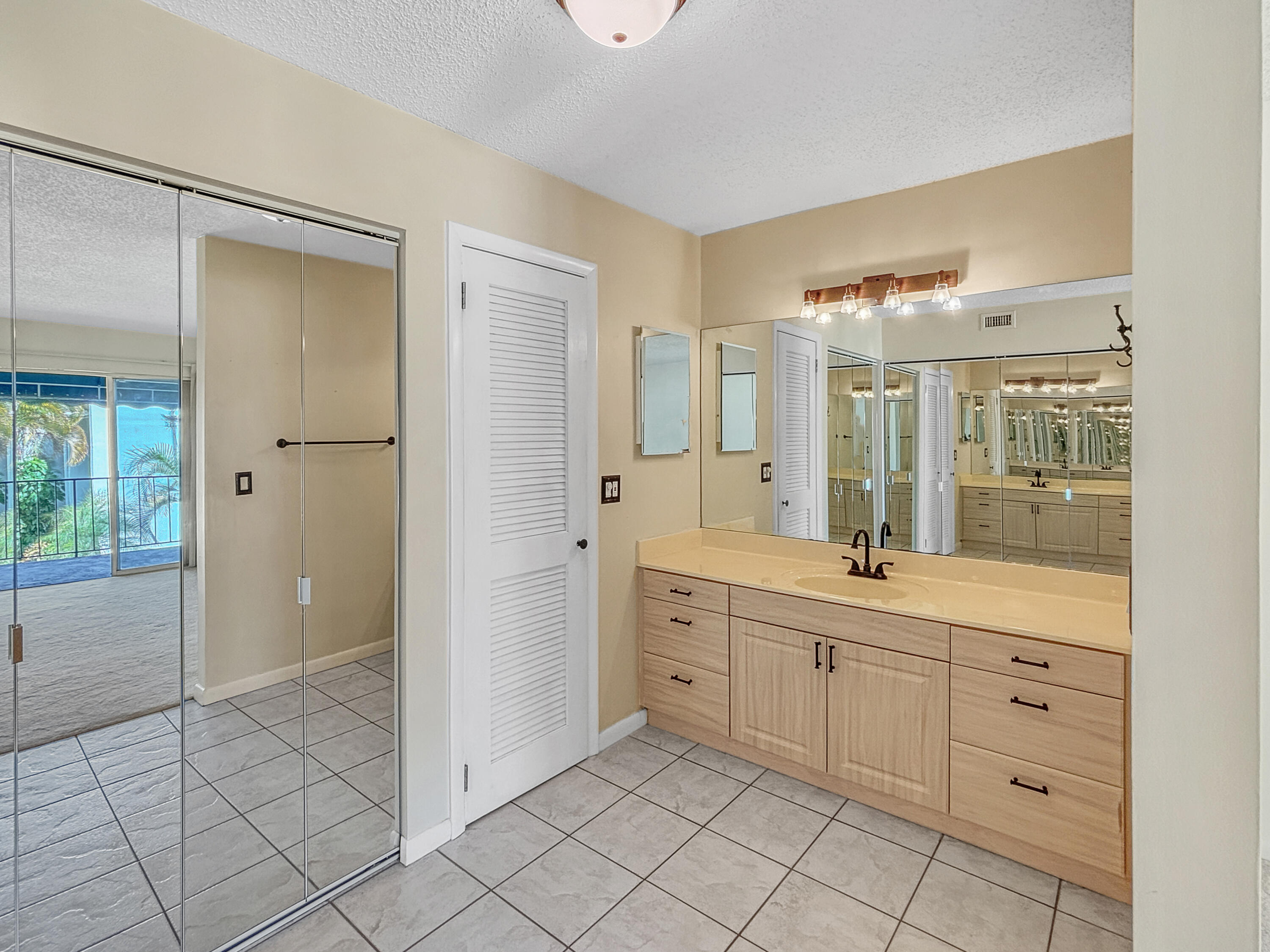 390 Golfview Road, Unit G North Palm Beach, FL 33408 - Photo 13 of 36 a spacious bathroom with a shower a sink and mirror