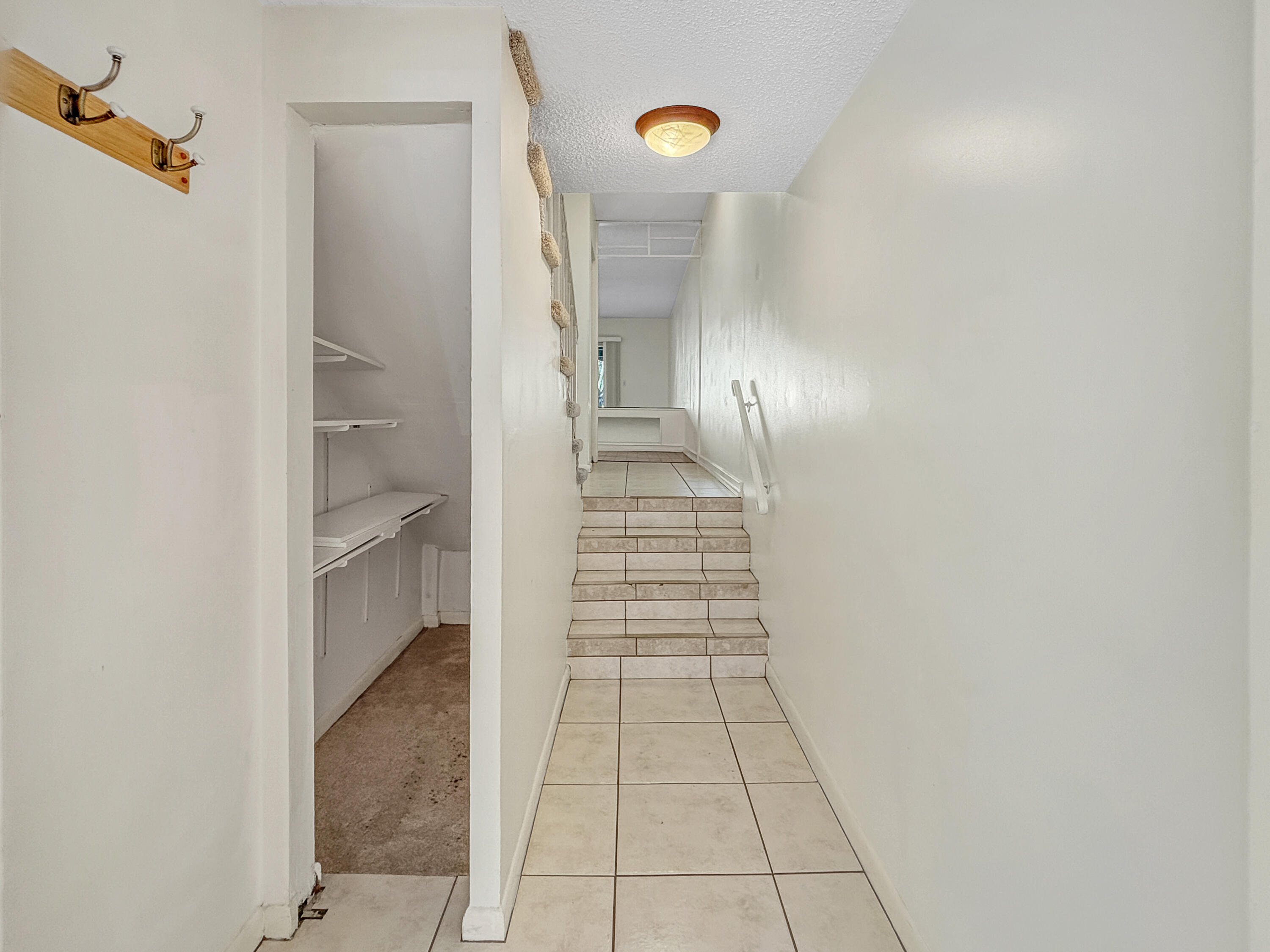 390 Golfview Road, Unit G North Palm Beach, FL 33408 - Photo 22 of 36 a view of a hallway with wooden floor and closet
