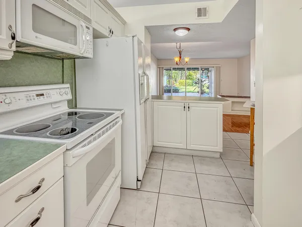 a kitchen with cabinets and appliances
