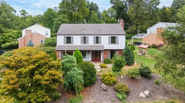 an aerial view of a house with a yard and potted plants
