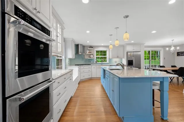 a large kitchen with stainless steel appliances kitchen island granite countertop a large counter top and stainless steel appliances