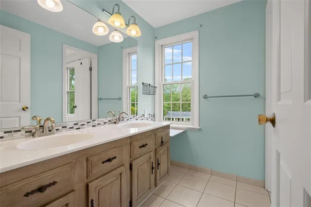 a bathroom with a double vanity sink and a mirror