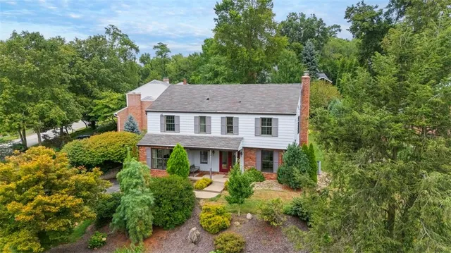 a aerial view of a house with yard and green space