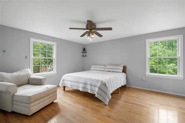 a bedroom with a bed couch and window