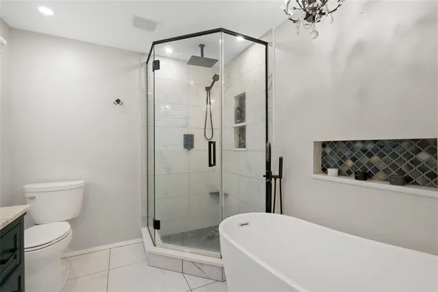 a bathroom with a toilet and shower