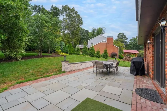 a view of a patio with a table and chairs