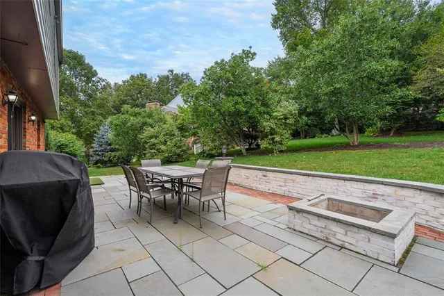 a view of a backyard with sitting area