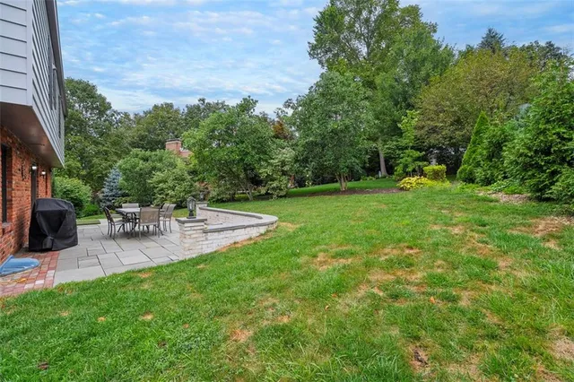 a view of a backyard with sitting area