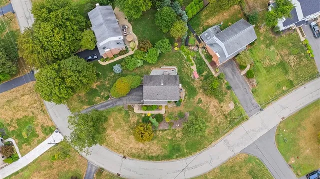 an aerial view of a house with a swimming pool