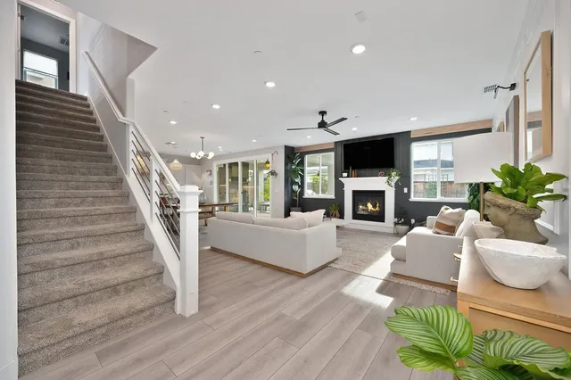a living room with furniture a flat screen tv and a fireplace