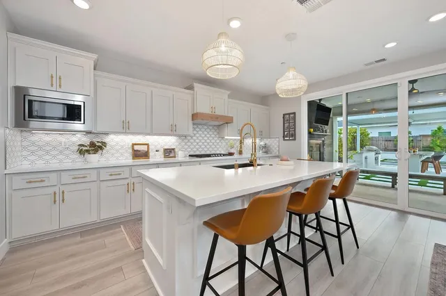 a living room with furniture and a dining table with kitchen view