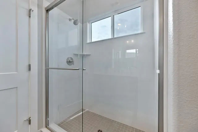 a spacious bathroom with a double vanity sink double mirror and bathtub