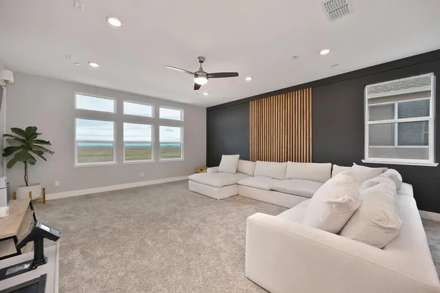 a view of an ocean with a floor to ceiling window