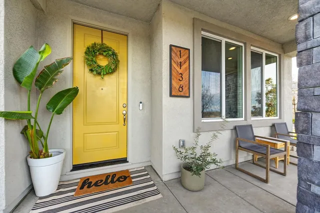 a kitchen with stainless steel appliances granite countertop a stove a sink dishwasher a refrigerator with a dining table and chairs