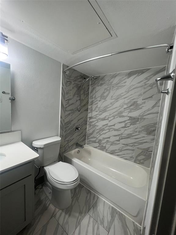 4633 Fairmount Street, Unit 213 Dallas, TX 75219 - Photo 7 of 9 Bathroom featuring vanity, light marble finish flooring, and shower combination