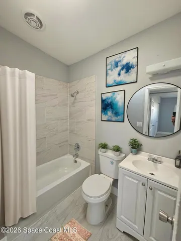 a bathroom with a toilet a sink and bathtub