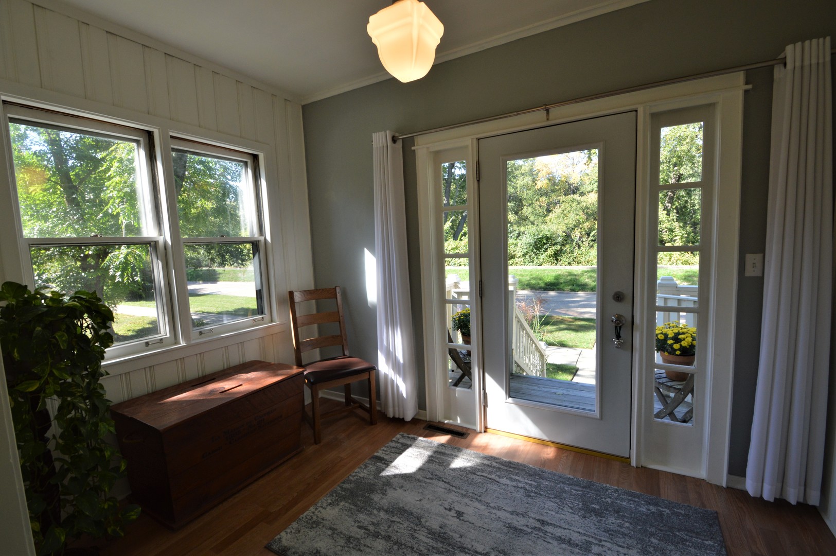 111 Groveland Avenue Riverside, IL 60546 - Photo 3 of 40 a view of an empty room with wooden floor and a window
