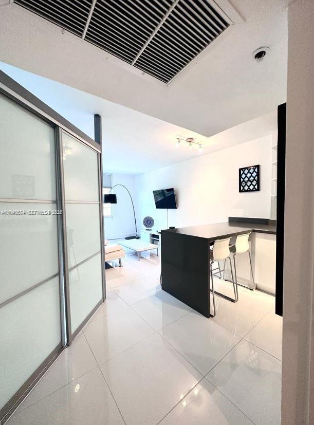 100 Lincoln Road, Unit 526 Miami Beach, FL 33139 - Photo 11 of 19 a living room with stainless steel appliances furniture a refrigerator and a kitchen view