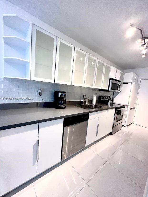 100 Lincoln Road, Unit 526 Miami Beach, FL 33139 - Photo 13 of 19 a kitchen with stainless steel appliances granite countertop a sink a stove and a refrigerator