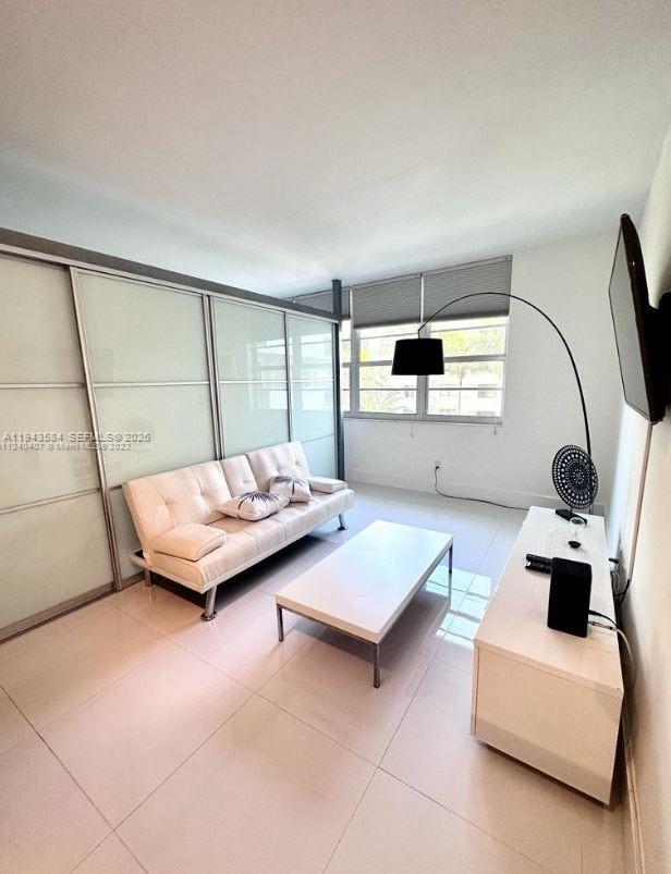 100 Lincoln Road, Unit 526 Miami Beach, FL 33139 - Photo 15 of 19 a living room with furniture and a large window