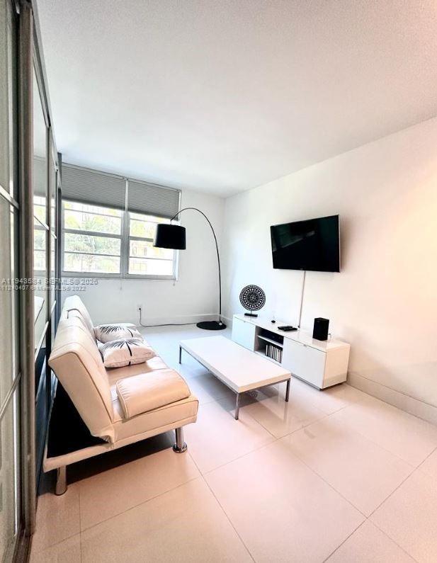 100 Lincoln Road, Unit 526 Miami Beach, FL 33139 - Photo 16 of 19 a living room with furniture and a flat screen tv