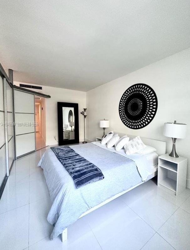 100 Lincoln Road, Unit 526 Miami Beach, FL 33139 - Photo 19 of 19 a bedroom with a bed and a walk in closet