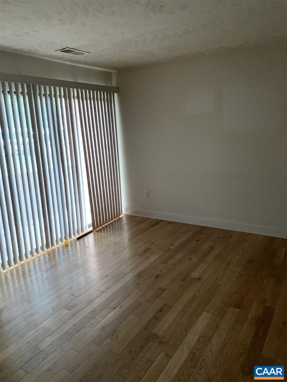 118 Turtle Creek Road, Unit 1 Charlottesville, VA 22901 - Photo 2 of 7 an empty room with wooden floor and windows