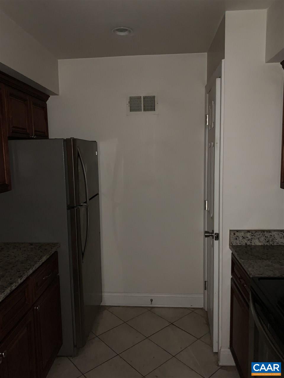 118 Turtle Creek Road, Unit 1 Charlottesville, VA 22901 - Photo 4 of 7 a kitchen with a refrigerator and cabinets