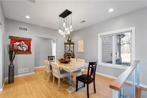 a view of a dining room with furniture wooden floor and chandelier