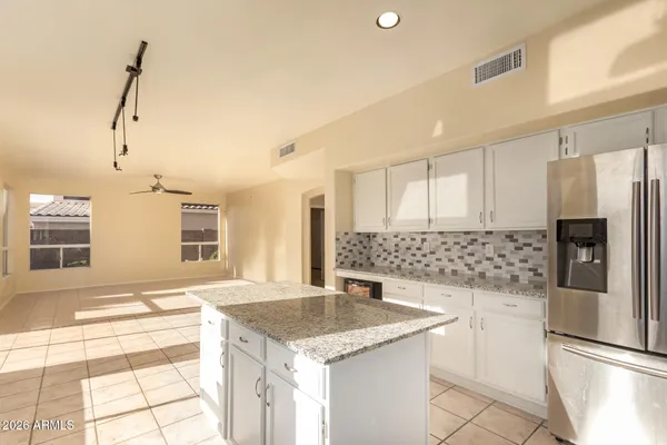a kitchen with stainless steel appliances granite countertop a sink and a refrigerator