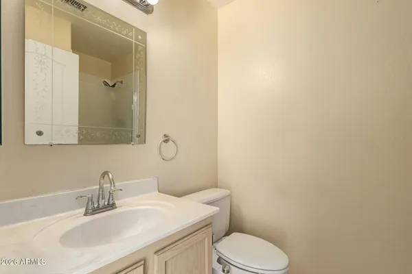 a bathroom with a sink a toilet and mirror