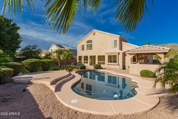 a view of a house with pool and trees
